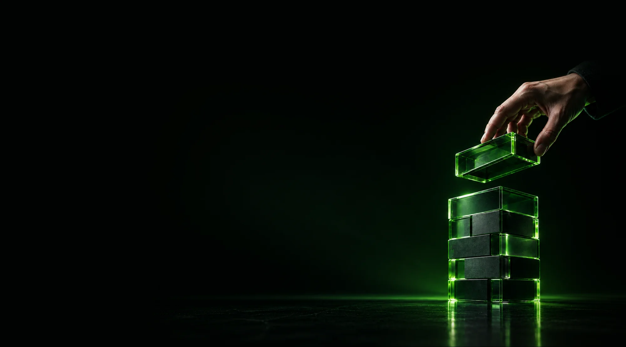 A hand placing a glowing green block onto a translucent stack