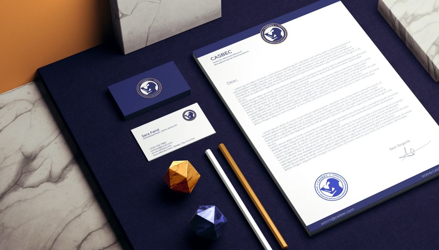 CASBEC business cards in navy with the gold emblem