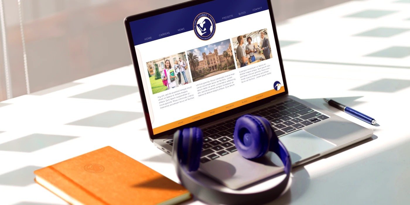 CASBEC website shown on a laptop — navy and gold with student photography