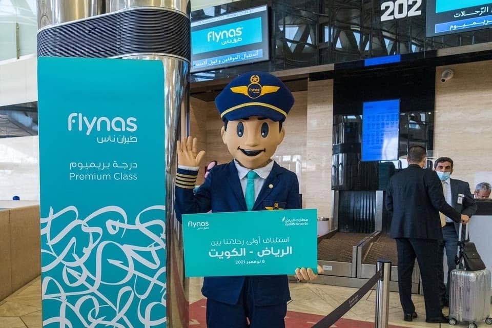 Captain Firnas mascot marking the Riyadh–Kuwait route launch at the airport