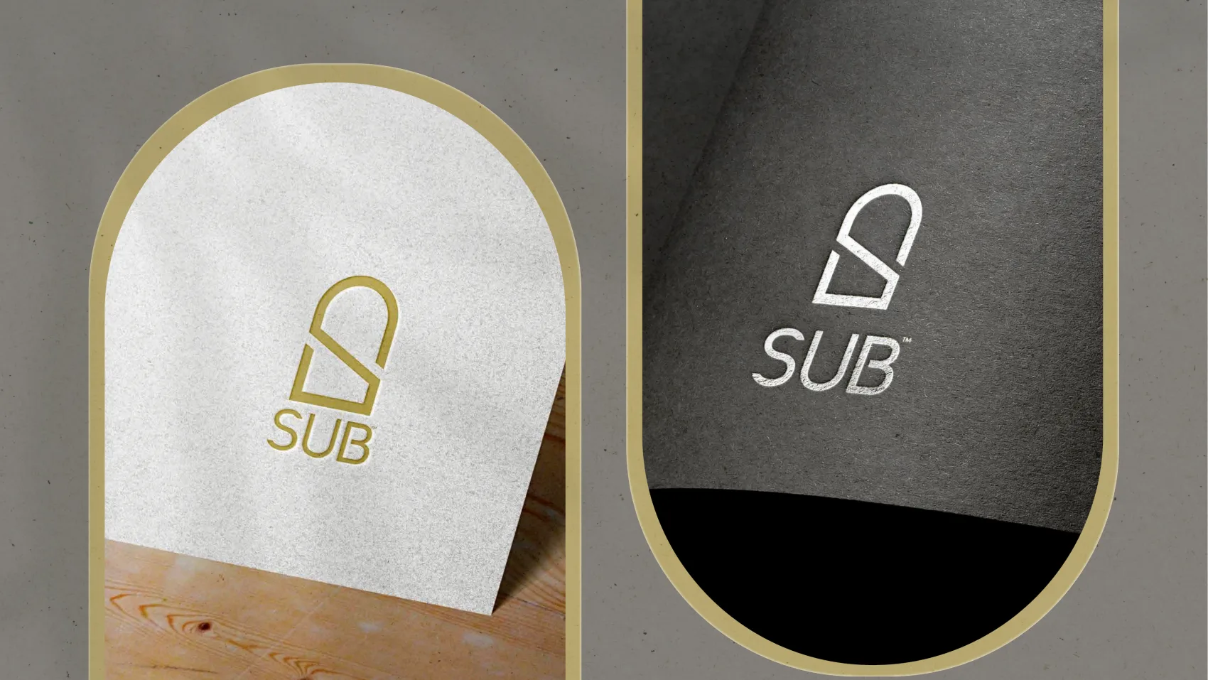Two arch-shaped cards carrying the SUB mark — one cream with gold foil, one dark grey
