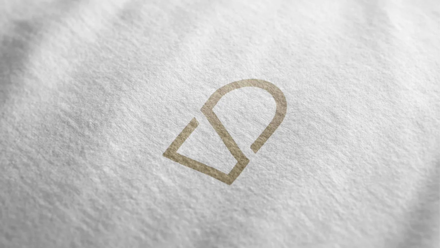 The SUB mark printed in gold on white fabric