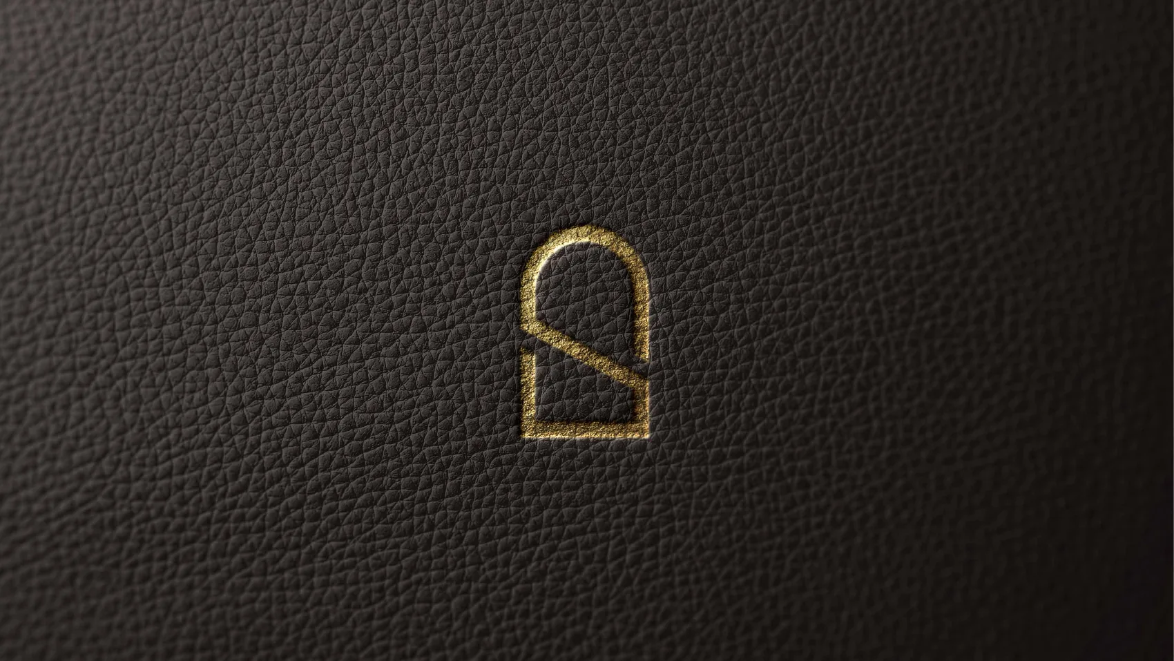 The SUB mark blind-embossed in gold on dark leather