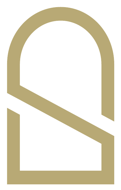 The SUB arch monogram in gold