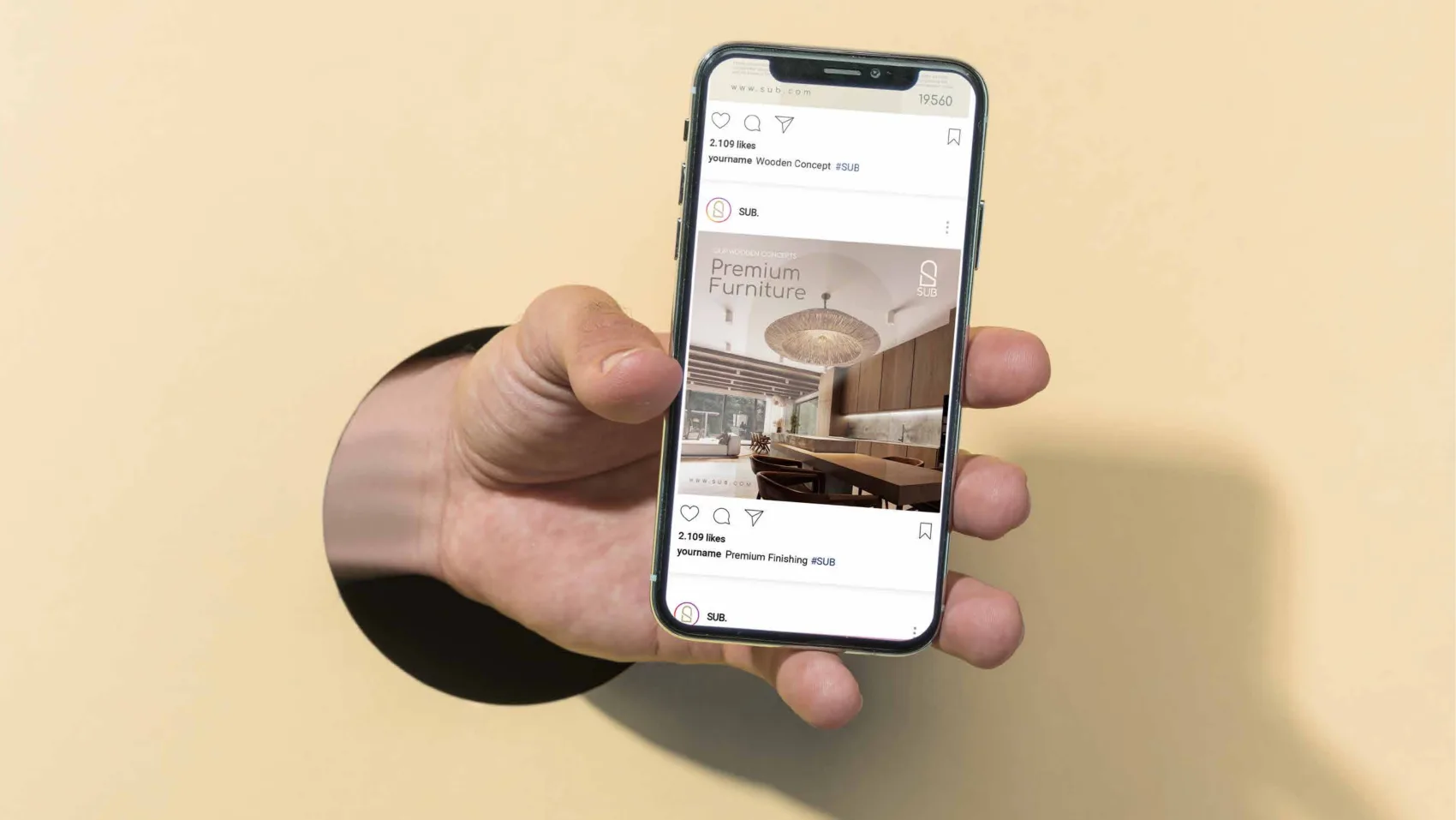 A hand holding a phone showing the SUB Instagram feed